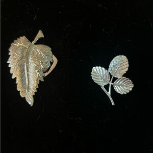 Two leaf brooches